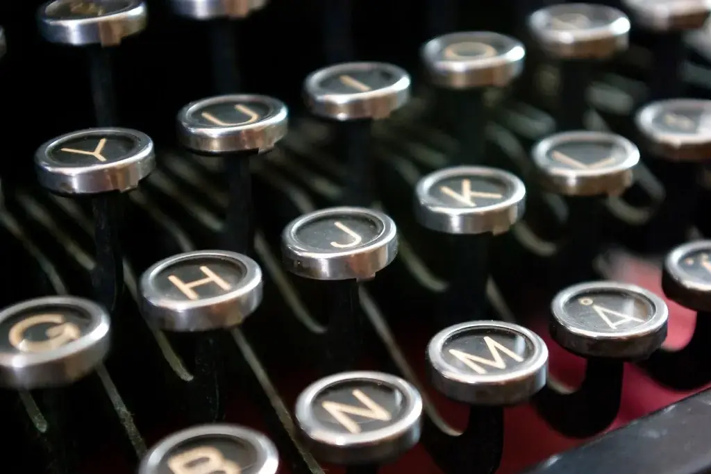 Round glass-topped typewriter keys, the letters of the middle row in focus